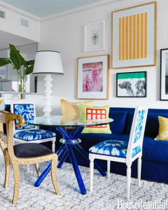 A blue and white apartment dining room with a table and chairs.