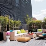A wooden deck with wicker furniture.
