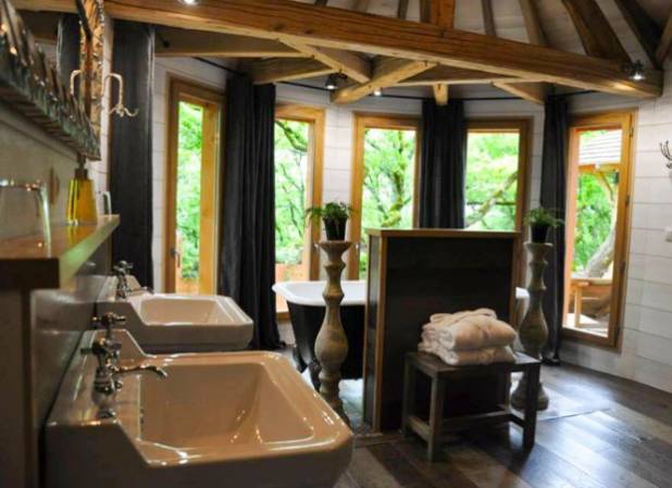 A bathroom with two sinks and a treehouse.