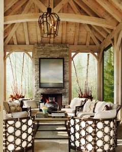 A living room with a fireplace and wicker furniture.