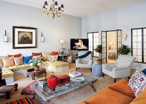 An eclectic living room with couches, chairs, and a coffee table.
