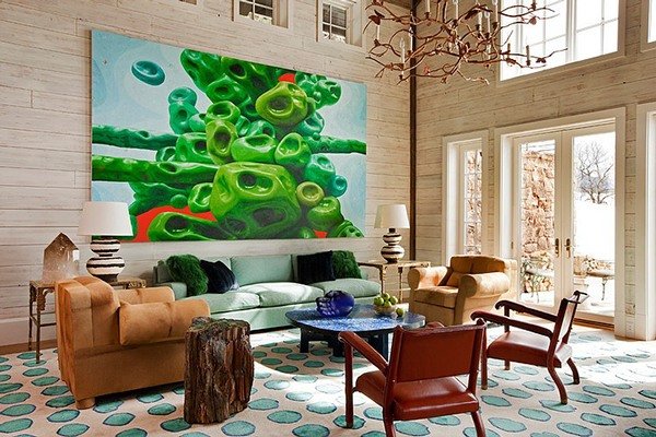 A living room with a large painting as the focal point.