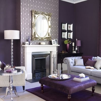 A monochromatic living room with purple walls and furniture.
