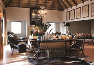 A living room with a thatched roof and safari decorating.
