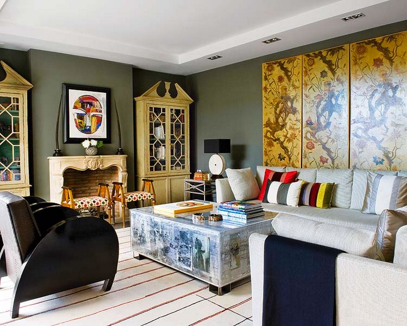An eclectic living room with a large painting on the wall.