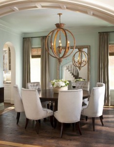 A dining room with a casually elegant round table and chairs.