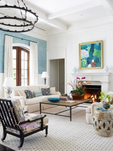A living room with blue walls and white furniture exudes casual elegance.