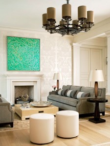 A living room with a vibrant painting on the wall.