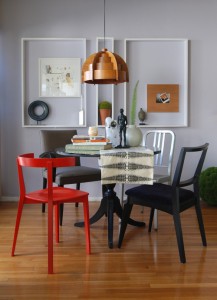 An eclectic dining room with a table and chairs.