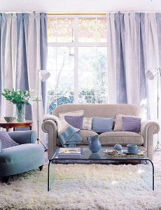 A living room with pastel-colored couches and a coffee table.