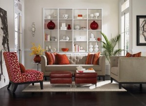 A living room with red and orange furniture featuring animal print accents.