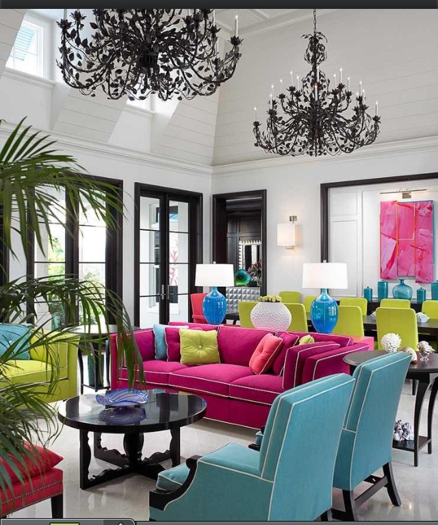 Bold decorating in a brightly colored living room with a chandelier.