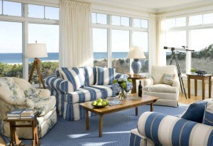 A cottage-style living room with blue and white striped furniture.