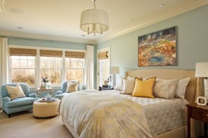 A serene bedroom with a window-front seating area