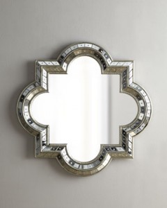 A silver mirror with a floral design for decorating.