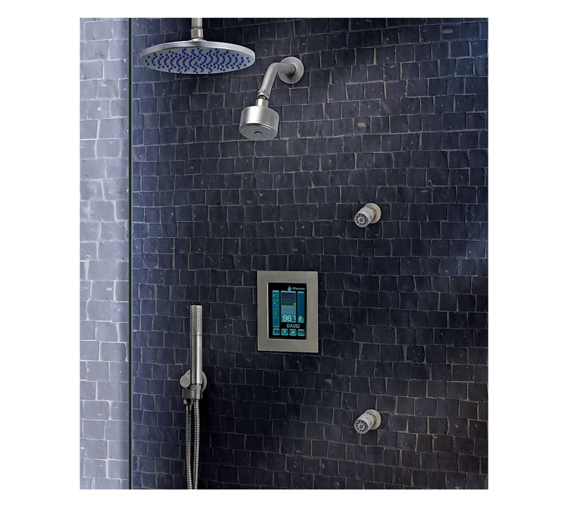 A blue tiled bathroom with a handheld shower head.