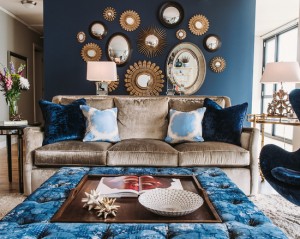 Light-brown-sofa-and-blue-egg-chair-with-mirrored-furniture-dining-room-chandelier-in-dark-blue-accent-wall-for-living-room