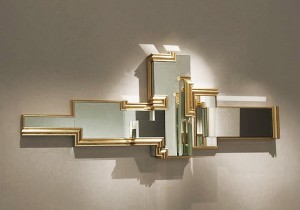 A gold mirror hanging on a wall, used for decorating.