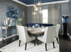 A dining room with a chandelier and unique color combinations.