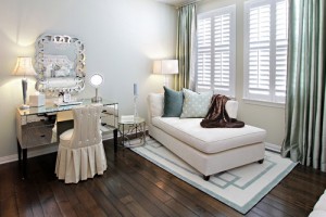 A master bedroom with white furniture.
