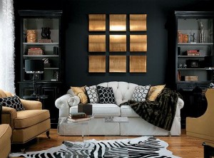 A black and gold living room with animal print accents, including a zebra rug.