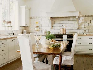 A white tiled kitchen decorated with white accents.