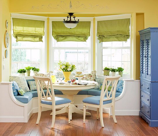 A yellow and blue dining room with banquette seating.
