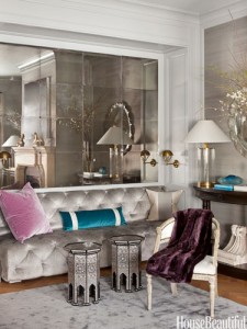 A living room with decorative mirrors and a cozy couch.