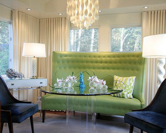 A living room with a green banquette seating.