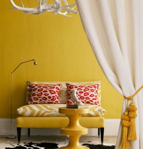 A yellow and white living room with a zebra rug featuring animal print.