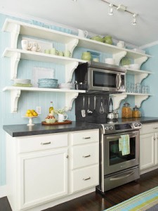 A kitchen with blue walls and white appliances featuring space-saving solutions.