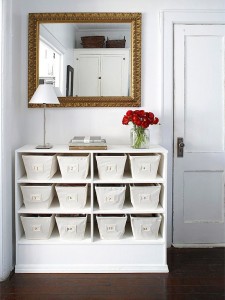 A white dresser with space-saving solutions including baskets and a mirror.