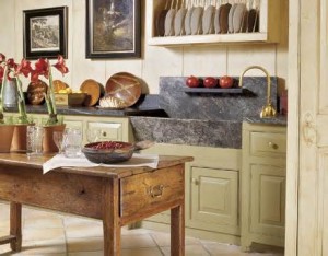 A cottage-style kitchen with a wooden table and a sink.