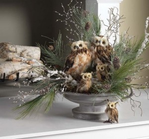 Owls and pine cones on a mantle for holiday decorating.
