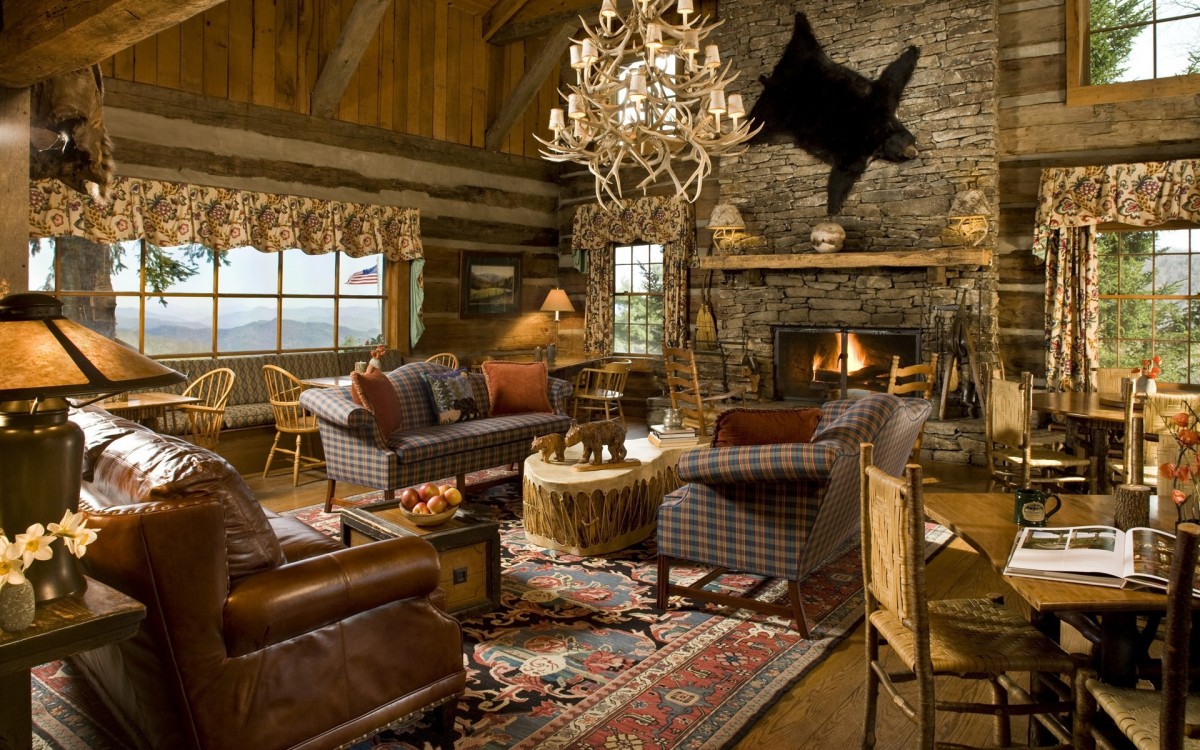 A rustic living room in a log cabin with a fireplace, perfect for those who want to live close to nature.
