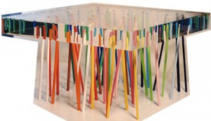 A versatile glass table with colorful sticks.