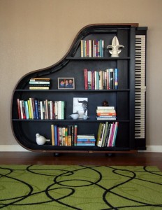 A creative bookcase made out of a piano, showcasing unique do-it-yourself shelf ideas.