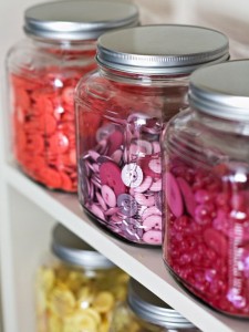 Colorful glass jars with buttons on a shelf, showcasing the allure of decorating.
