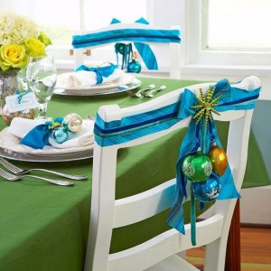 Festive Christmas table setting with blue and green decorations.