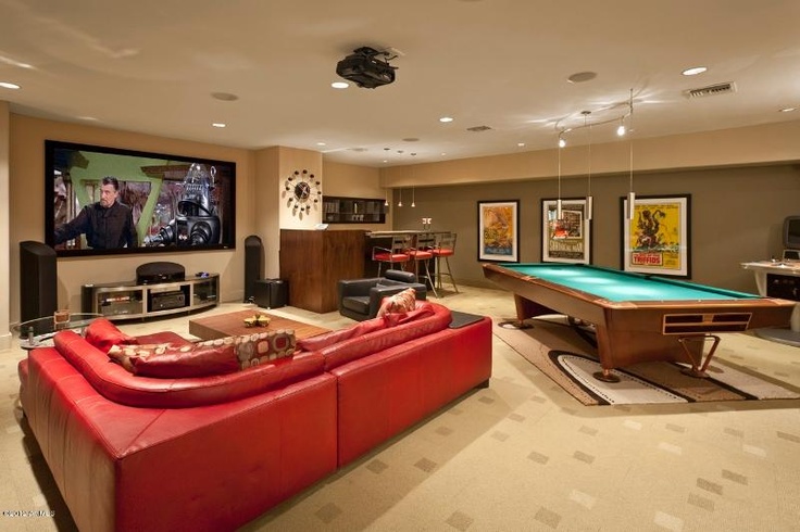 A home game room with a pool table and a tv.