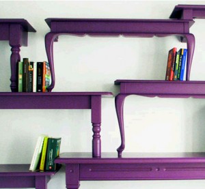 Do-it-yourself purple bookshelves on a wall.