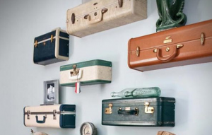 Vintage suitcases creatively mounted as do-it-yourself shelves.