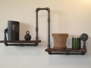 Creative and do-it-yourself pipe shelves with a potted plant on them.