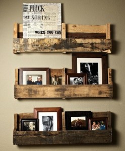 Creative DIY display of pictures on three wooden shelves.