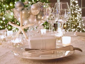 Festive Christmas table setting with silverware and decorations.