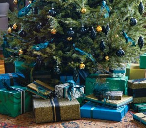 A Christmas tree decorated with blue and green presents.