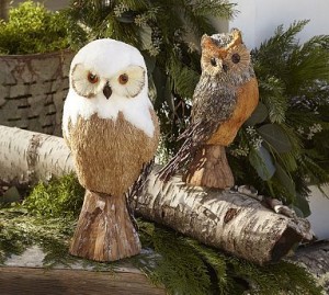 Two festive owls perched on a log, ready for holiday decorating.