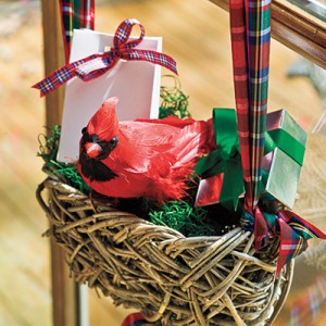 A red cardinal perched in a wicker basket, perfect for decorating with birds this holiday season.