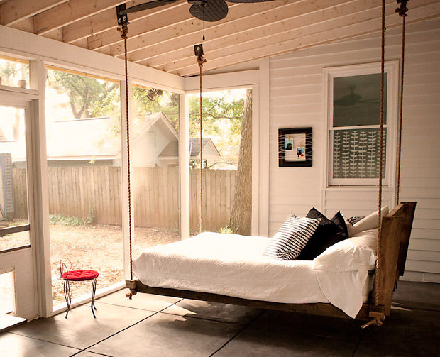 An indoor swing bed in a bedroom.