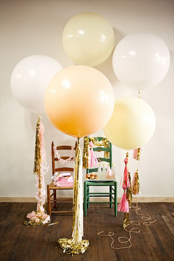 A group of balloons with tassels, perfect for a New Year's Eve party decoration.